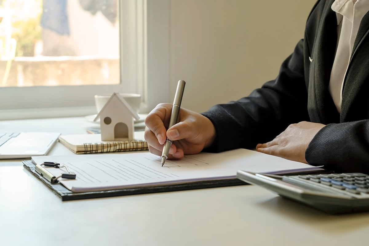 Businessman writing information on a notebook on his desk, working ideas, and taking notes of financial details. Businessman writing information on a notebook on his desk, worki