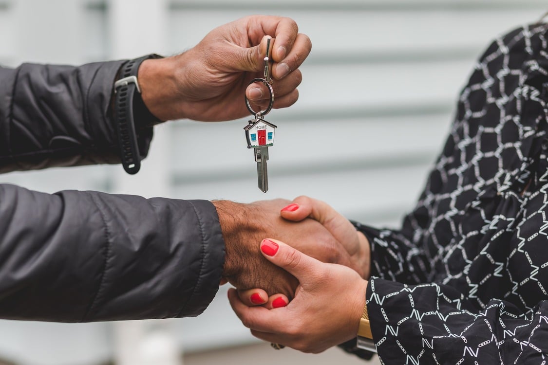 Real Estate Agent handing out keys to buyers